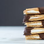 stack of 5 smores bites on a white counter with black background