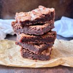 stack of 5 fudgy brownies on top of brown wax paper