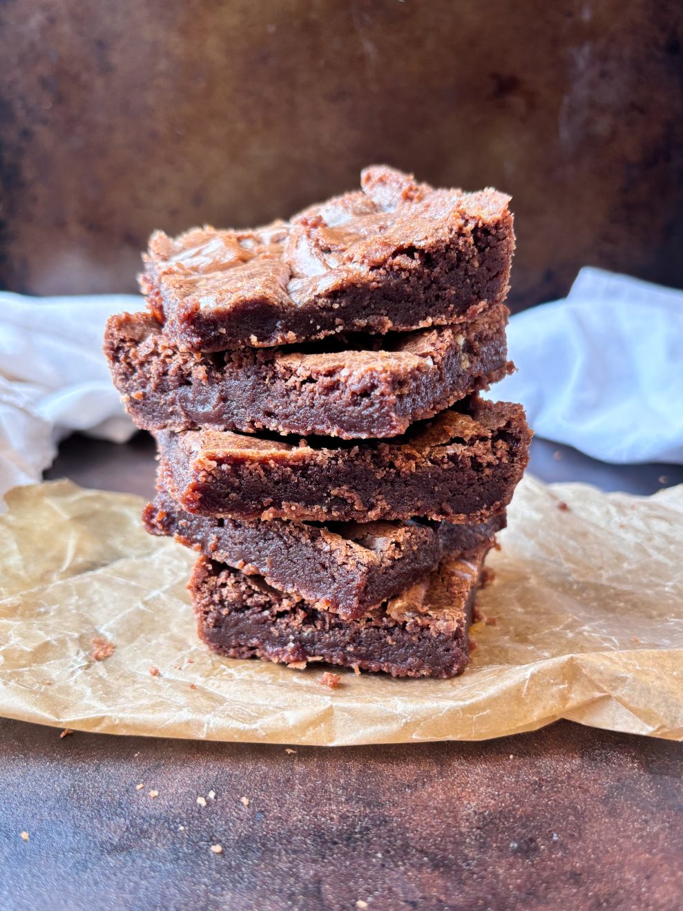 stack of 5 fudgy brownies on top of brown wax paper