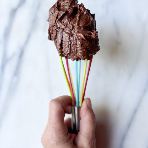rainbow whisk with a dollop of chocolate american style buttercream on the top