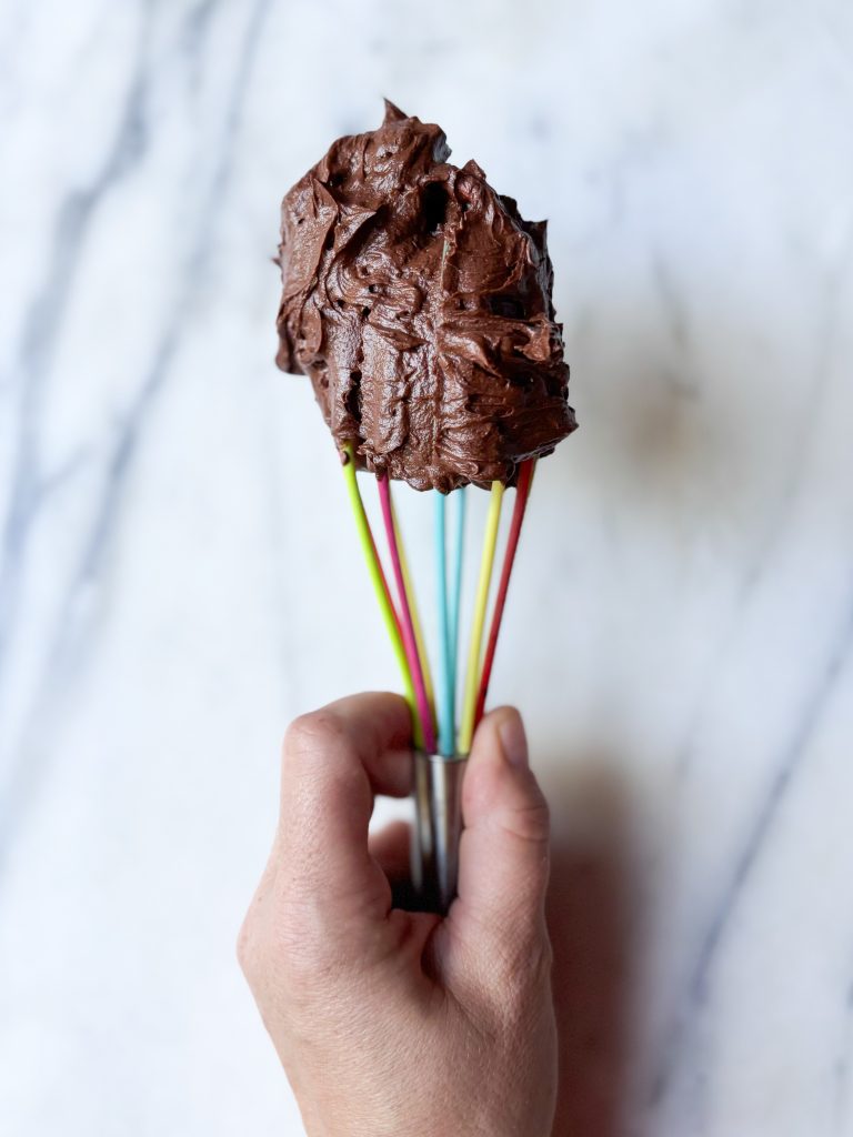 rainbow whisk with a dollop of chocolate american style buttercream on the top