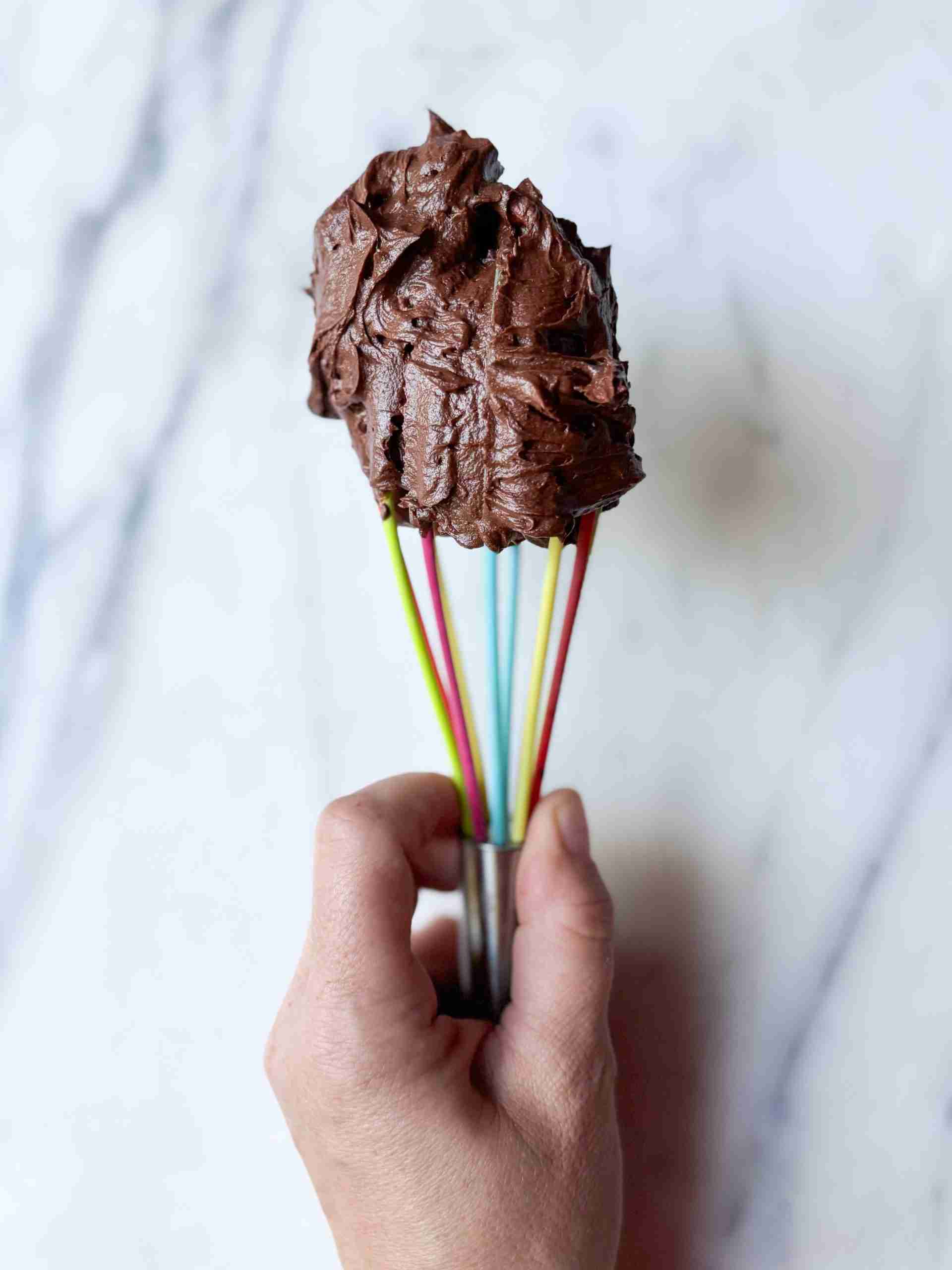rainbow whisk with a dollop of chocolate american style buttercream on the top